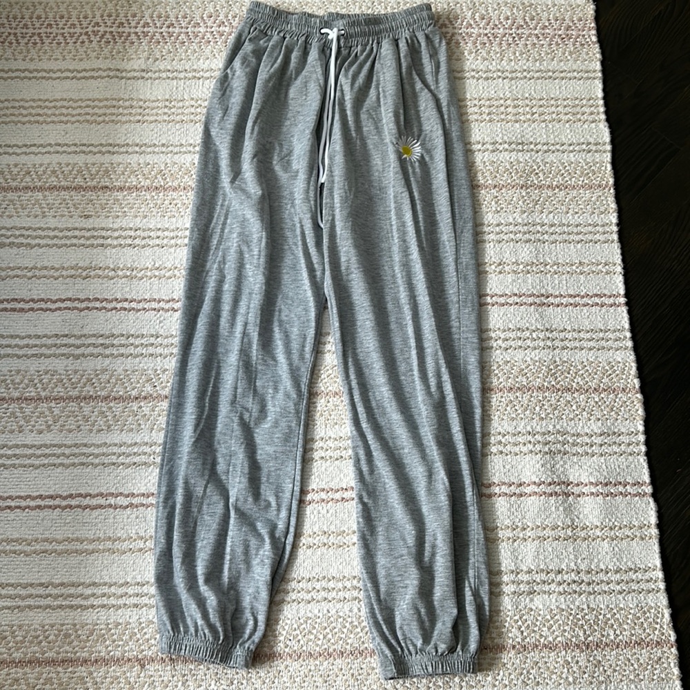 light gray sweatpants w small sunflower embroidered